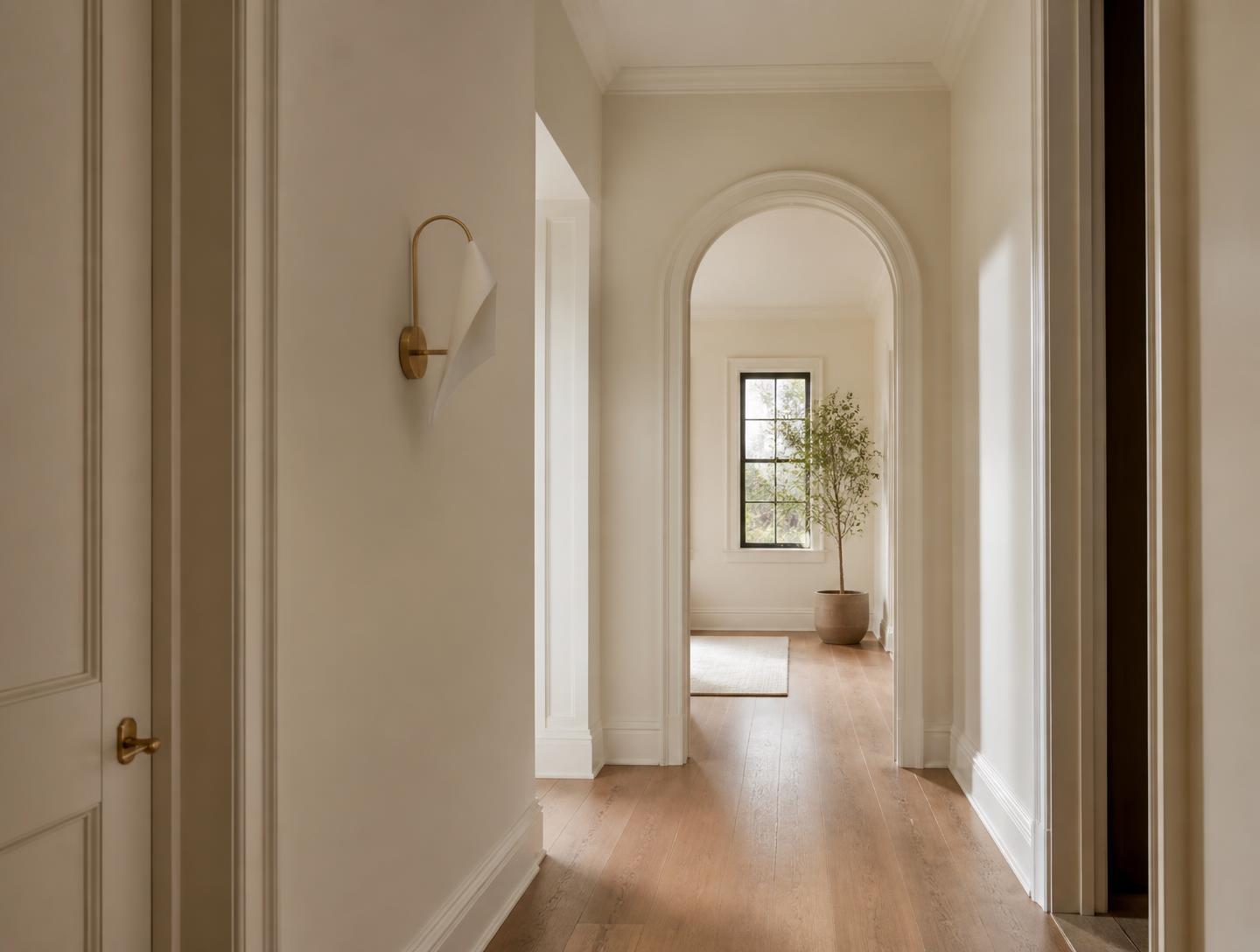 Freshly finished interior hallway with warm limestone walls, crisp trim and an arched doorway